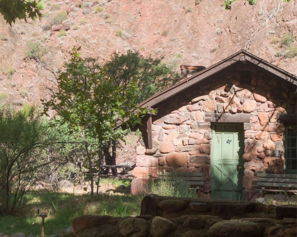 stone cabin with a green door.