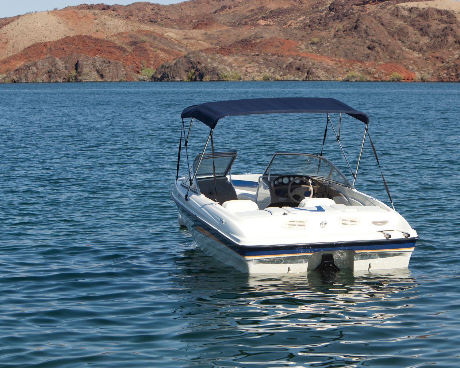 a white boat floating on a peaceful Arizona lake.